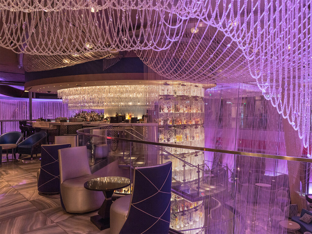 Grab a drink at the purple hued bar, The Chandelier inside The Cosmopolitan of Las Vegas.