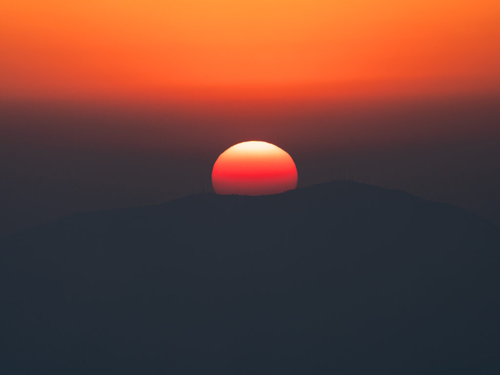 Sun sets behind the mountains at Sony Kando Trip near Salt Lake City.
