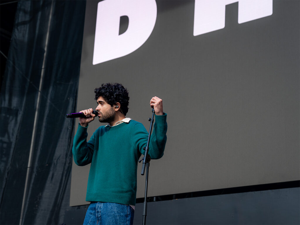 Dhruv holds the microphone stand and sings at HITC.