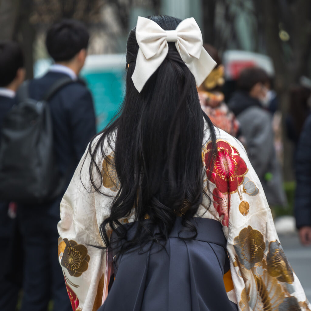 A Japanese college graduate in Tokyo wears a beautiful kimono and a ribbon in her hair.